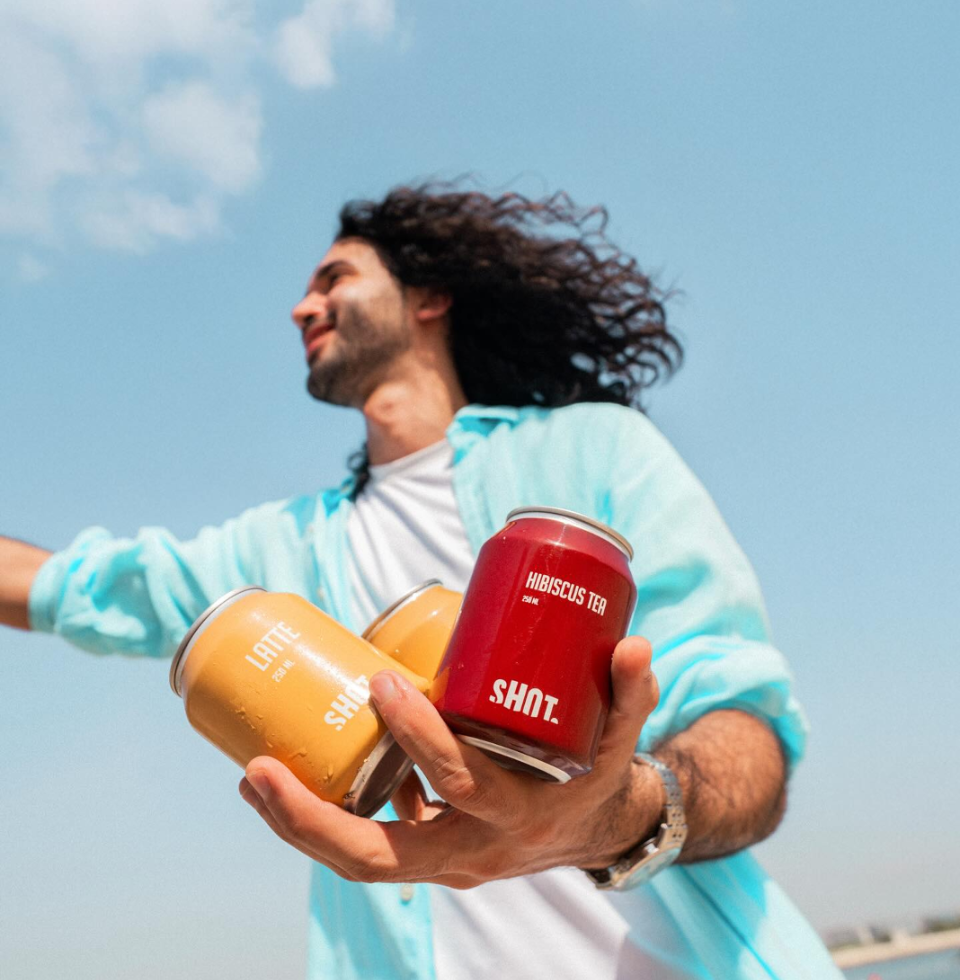 Man holding coffee cans