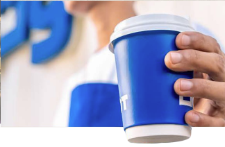 Person holding blue Shot coffee cup